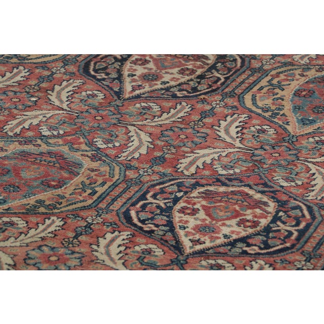 Made with hand-knotted wool circa 1910-1920, this 12x15 antique Persian rug is a rich and rare collectible of Kerman Lavar...
