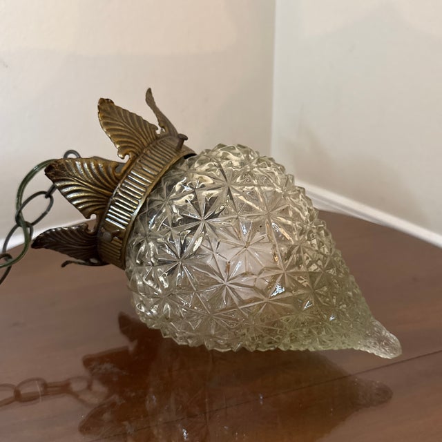 Bring timeless charm to your space with this vintage pineapple pendant light, featuring a beautifully textured cut glass...