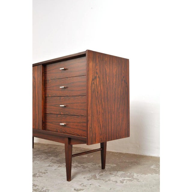 Stylish 1960s sideboard with four drawers and two doors (white back panel). The beautiful rosewood exudes a certain class!...