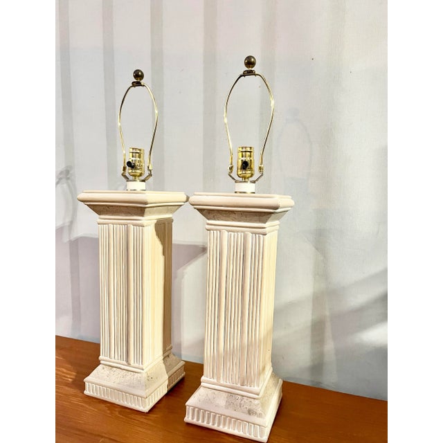 A pair of Vintage Coastal Style Pencil Split Reed Rattan and Faux Stone Table Lamps. Circa 1980s Feature a soft cream...