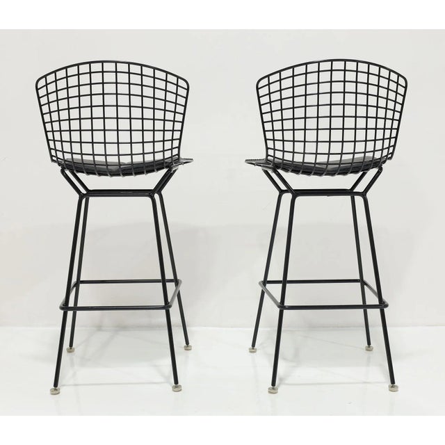 Elevate your home decor with the Pair of Bertoia Bar Height Stools in Black, featuring luxurious Volo Leather Seat Pads....