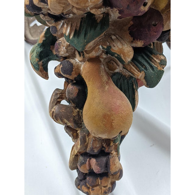 A richly decorative vintage six-light chandelier featuring an elaborately hand-carved wood central column adorned with...
