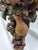 A richly decorative vintage six-light chandelier featuring an elaborately hand-carved wood central column adorned with...