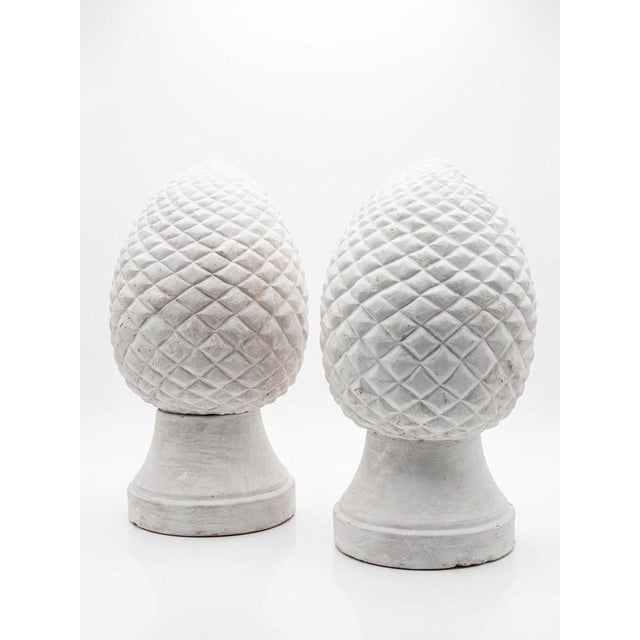 A striking pair of vintage terracotta garden finials, beautifully sculpted in the form of traditional pinecones....