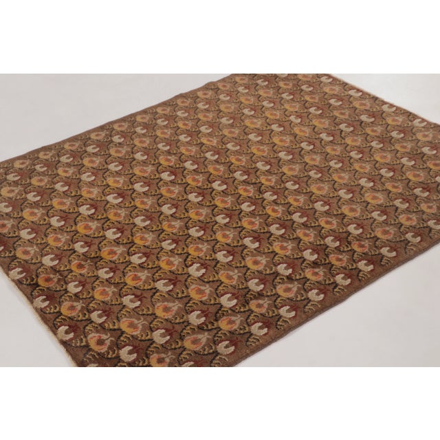 A vintage Turkish hand-knotted wool rug from the 1950s–1960s featuring an elegant allover floral pattern in warm walnut,...