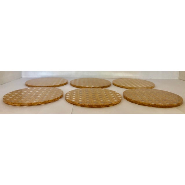 Cool set of 6 italian coasters from the 80s. Clear Lucite with inserted brown caning. Large and very decorative.