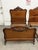 Design Plus Gallery presents an Antique Louis XV Style Carved Wood Twin Bed Frame. The bed showcases a shaped headboard...