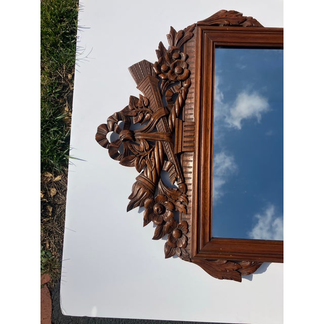 This finely carved mirror was created in the French style of the 18th century Most unusual is the solid wood backing...