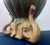 A striking vintage sculptural cachepot featuring three elephants supporting a ribbed lotus-form planter with a beautiful...