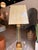 This contemporary transitional table lamp showcases a refined mix of gilded iron and tempered glass, creating a...