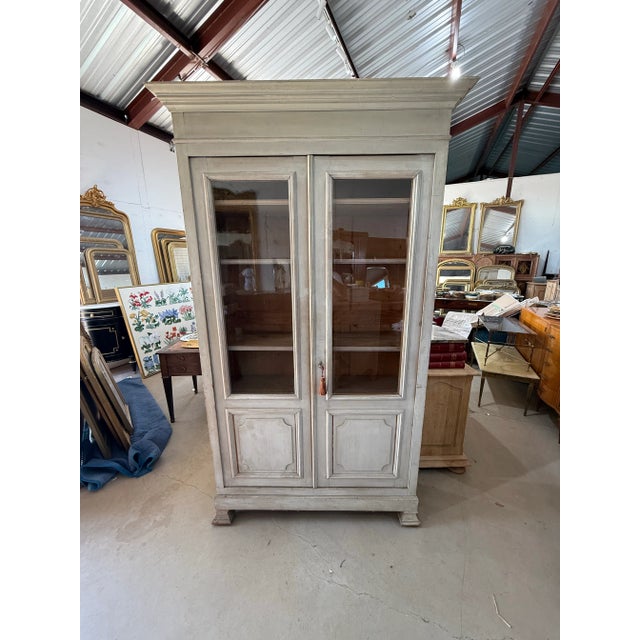 French 19th century louis Philippe 2 door bookcase made of solid walnut. The wood has the original French paint from the...