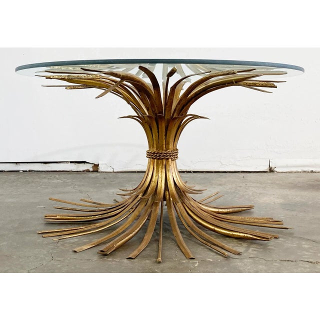 Statement vintage Mid-Century Hollywood Regency style gilt metal sheaf of wheat table. Gorgeous piece that will add...