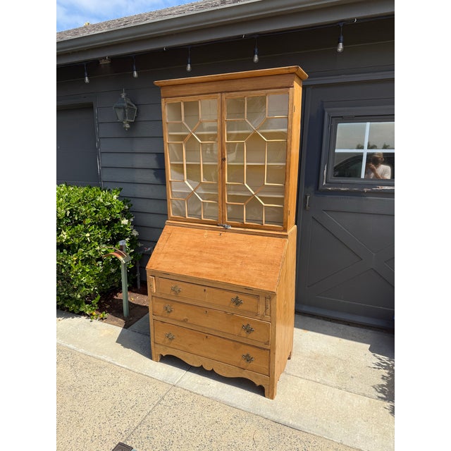 This is a beautiful pine secretary from the with three bottom drawers below and a desk area up top with loads of space....