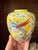 This vibrant vintage chinoiserie-style ginger jar features colorful pheasants perched among blooming branches against a...