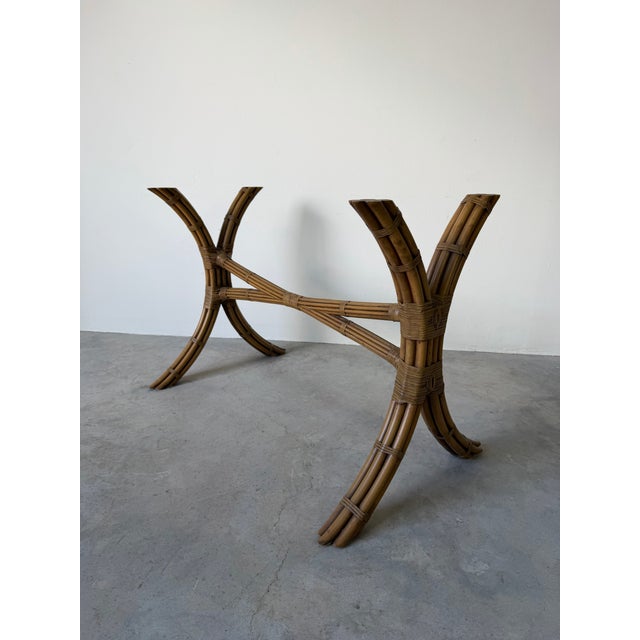 Beautiful vintage coastal dining table in the style of McGuire, featuring an elegant sculptural base crafted from bundled...