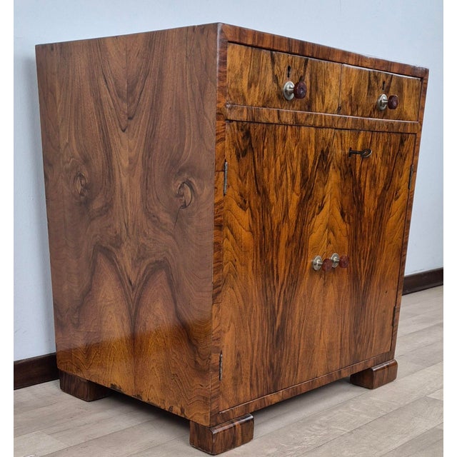 This cabinet, entirely made of blond walnut burl, originally designed as a record rack, features an exclusive design. The...