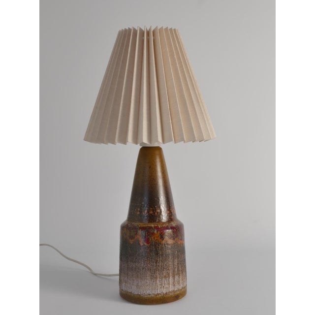 This Scandinavian modern brutalist stoneware lamp by Tilgmanns, originating from Sweden in the 1960s, is a striking...