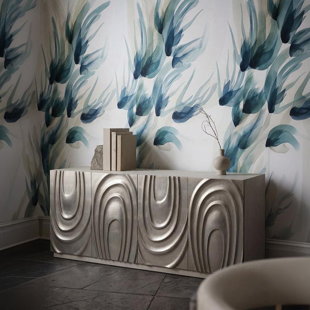 Carved doors turn the front of this long, low case into a sculptural surface. Each door is carved in deep, flowing...