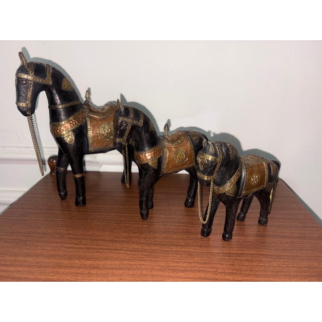Trio of antique hand-carved horses in wood, brass and copper, the large one is 21 cm high, 18 cm deep and 5 cm wide, the...