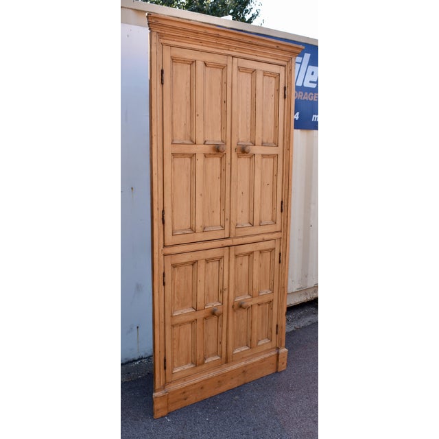 Each of the four wide-swinging doors on this impressive English Pine Corner Cupboard is divided into four panels. This, as...