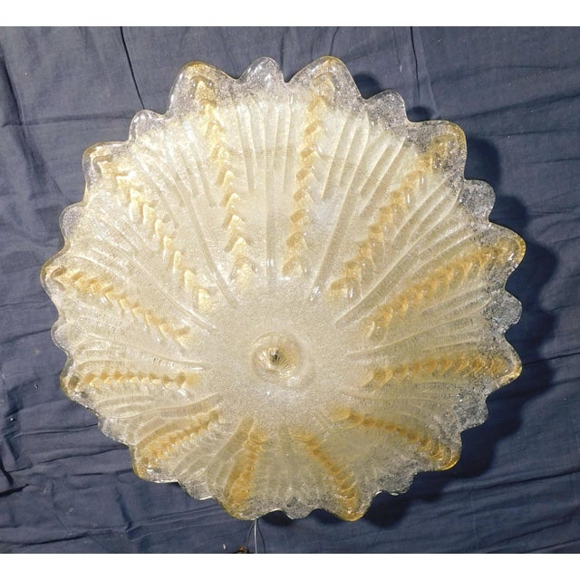 Italian flush mount with a clear and amber Murano glass diffuser hand blown in graniglia technique creating granular...