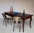 This early 20th century French walnut farm table presents a refined provincial silhouette, distinguished by elegantly...