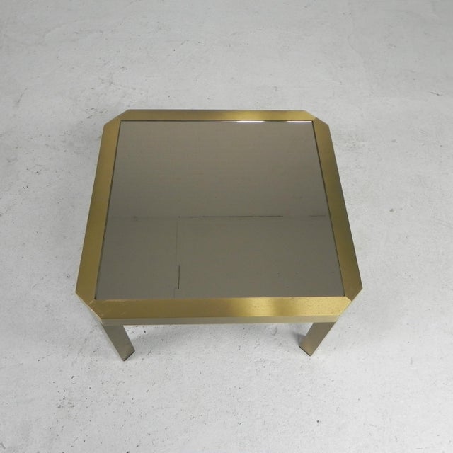 Height: 35 cm. Width: 58 cm. Depth: 58 cm. Dimensions bronze-colored mirror: 50 x 50 cm. Origin: Belgium, 1970s. Material:...