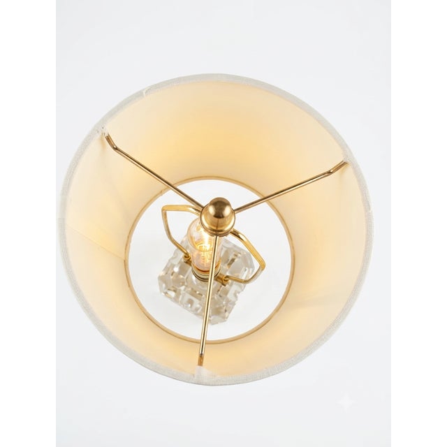 This is a faceted crystal apple-shaped lamp. The base is made of solid, heavy crystal with wide vertical facets/bevels cut...