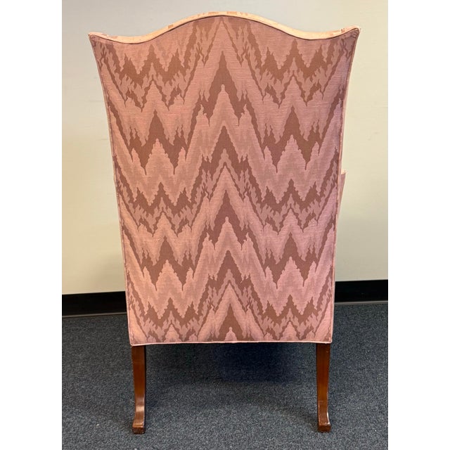 Beautifully crafted Southwood wingback chair featuring an elegant high back, gracefully sculpted wings, rolled arms, and...