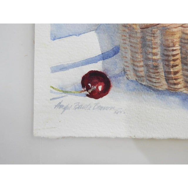 Late 20th century watercolor on paper still life with cherries and basket painting by Angie Banda Brown (1937-2016) Texas....