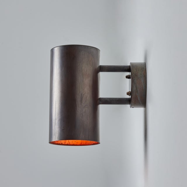 Hans-Agne Jakobsson C627/110 'Rulle' brown patinated outdoor sconces - a pair. Executed in richly patinated metal with raw...