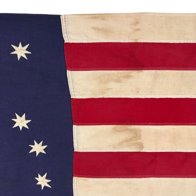 This vintage American Bennington flag is made from a cotton cloth, with fully embroidered emblem and sewn stripes. Please...