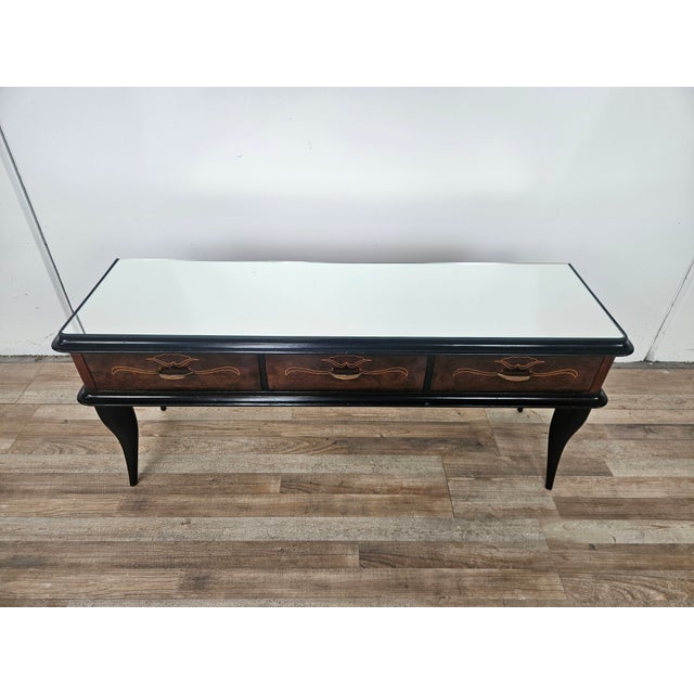 1960s-style entryway or dressing table clad in mahogany burl with brass trim and decorations. The mirrored top and black...