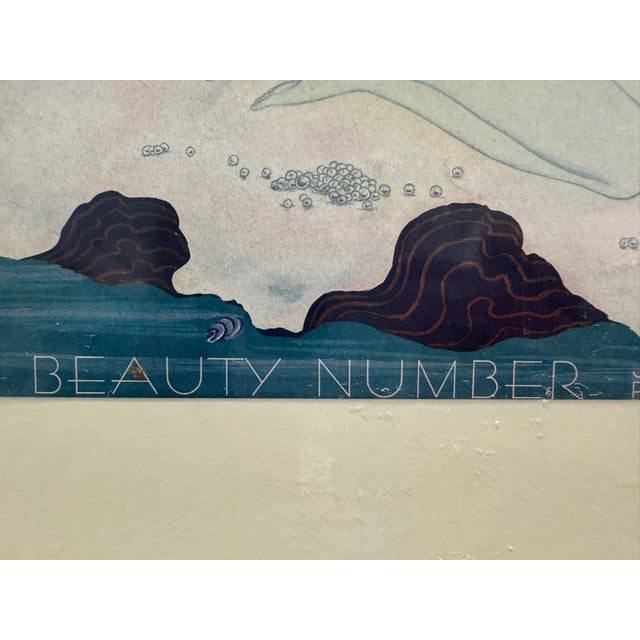 Original period front cover from the July 1933 issue of Vogue magazine, featuring a graceful Art Deco nude figure adorned...