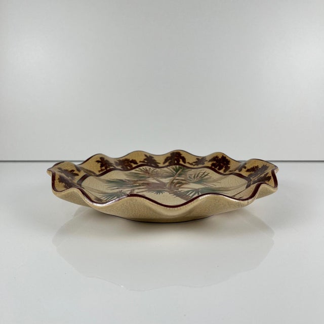 Crackle-glazed earthenware dish with an exotic design of monkeys and palm trees, first half of the 20th century....