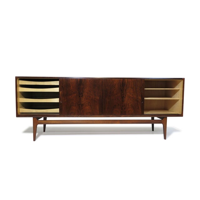 This Danish Credenza, designed and handcrafted in Denmark, 1952, is expertly handcrafted from Brazilian rosewood,...