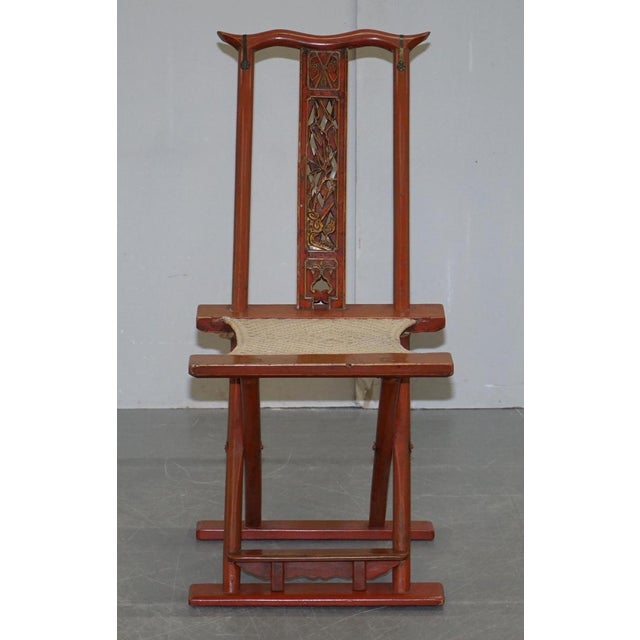 Original Chinese red lacquered fret work carved folding chair with woven seat . A very good looking and decorative antique...