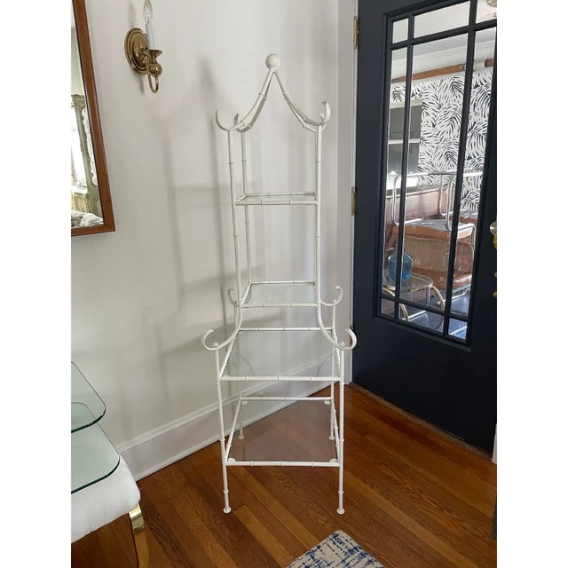 Mid Century Pagoda form faux bamboo etagere in painted metal with four removable glass shelves.