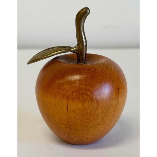 Vintage carved wood apple with a brass stem. Perfect as decorative accessory or paper weight. Age wear. Patina to brass.