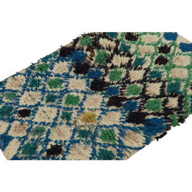 Hand-knotted in wool circa 1950-1960, this vintage 3x4 Moroccan scatter rug is believed to hail from the Azilal tribe. On...