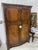 An early 20th century two door armoire of figured mahogany by Waring & Gillow of Lancaster, England. This armoire has a...