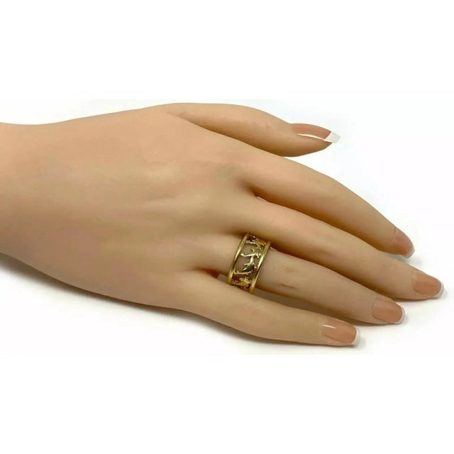 This lovely band ring is crafted from 14k yellow gold with a polished finish and features a 10mm wide band with full...