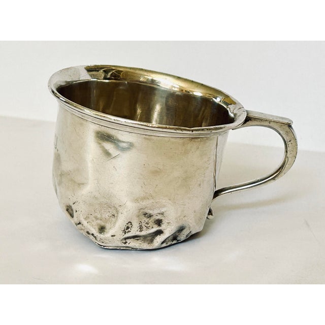 A sterling silver child's cup (often referred to as a christening cup or baby mug) featuring these exact hallmarks is a...
