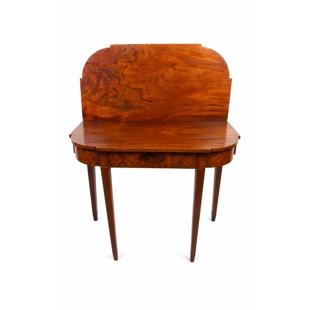 A refined early 19th-century American Federal card table, crafted in richly figured mahogany with exceptional flame...