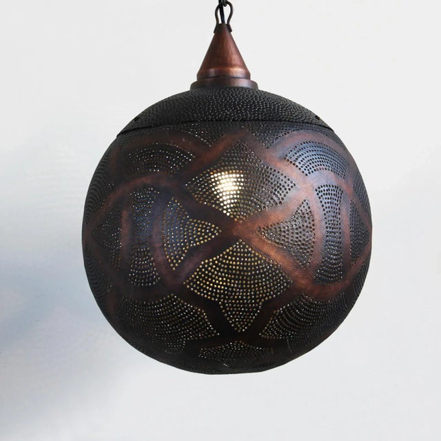 Antiqued copper globe lantern with perforated moorish design patterns that shine beautiful patterns onto walls and...