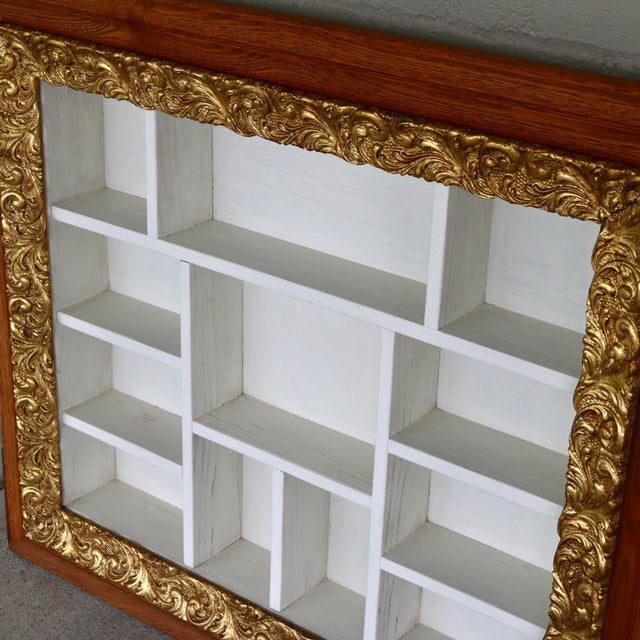 Elevate your display game with this striking vintage wall curio cabinet. This unique statement piece features a robust,...