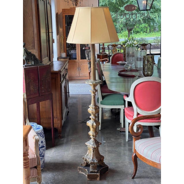 Carved floor lamp in the form of an altar candlestick, the baluster shaft with knopped and faceted sections rising to a...