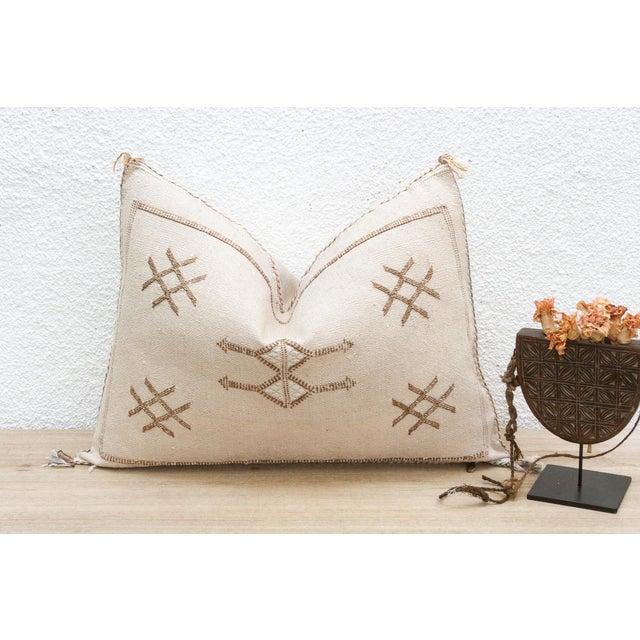 Introduce a touch of earthy elegance with our handcrafted lumbar/rectangular Moroccan cactus silk pillow. Woven from the...