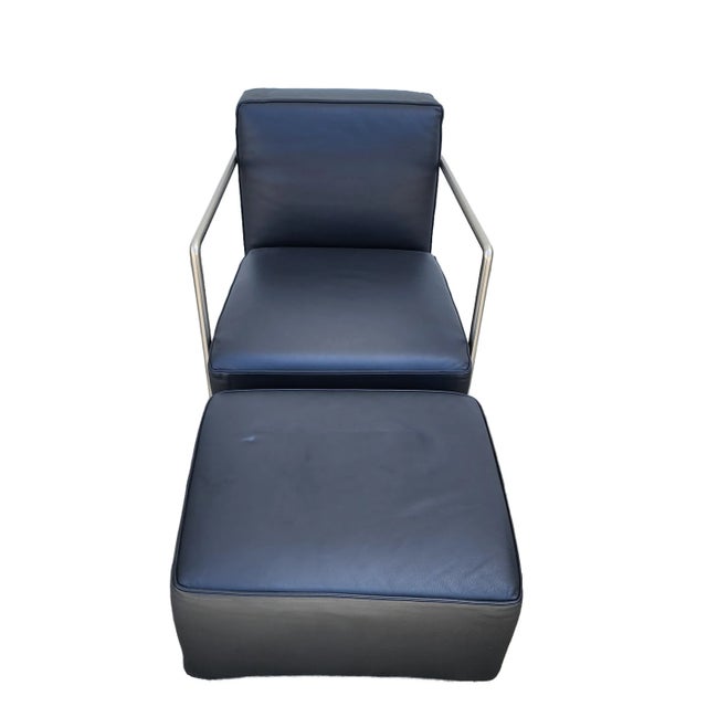 The Camerich Contemporary Italian Metal and Leather Armchair and Ottoman is a stylish and modern seating option for any...