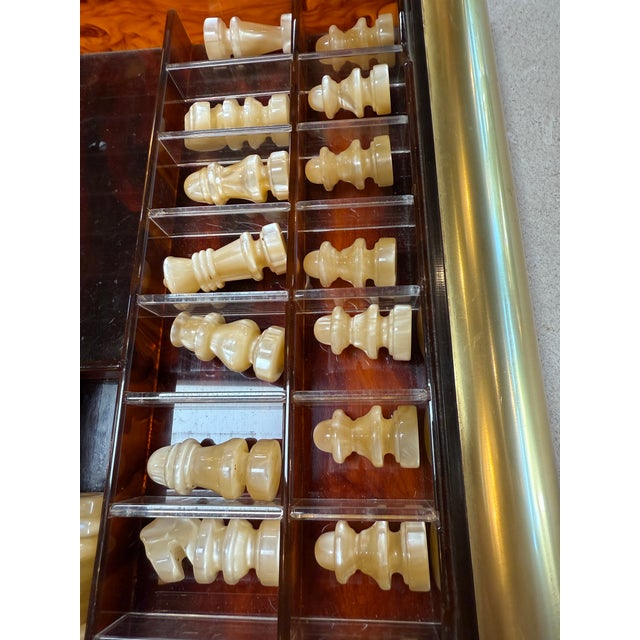 Sophisticated Italian chess set from the 1970s, crafted in rich tortoiseshell-pattern Lucite with polished brass accents....